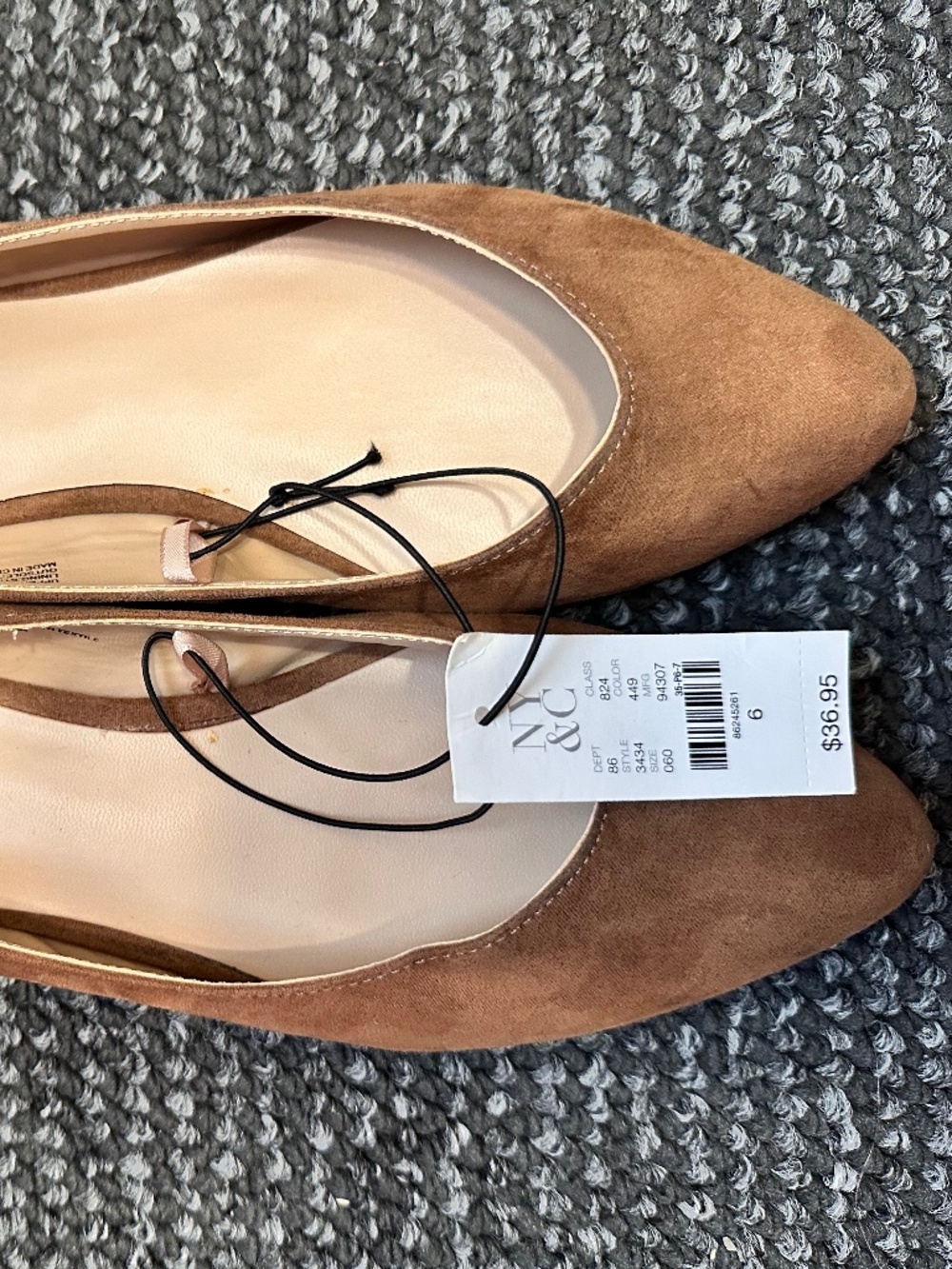 These brown New York & Company flats feature a pointed toe and a soft suede-like